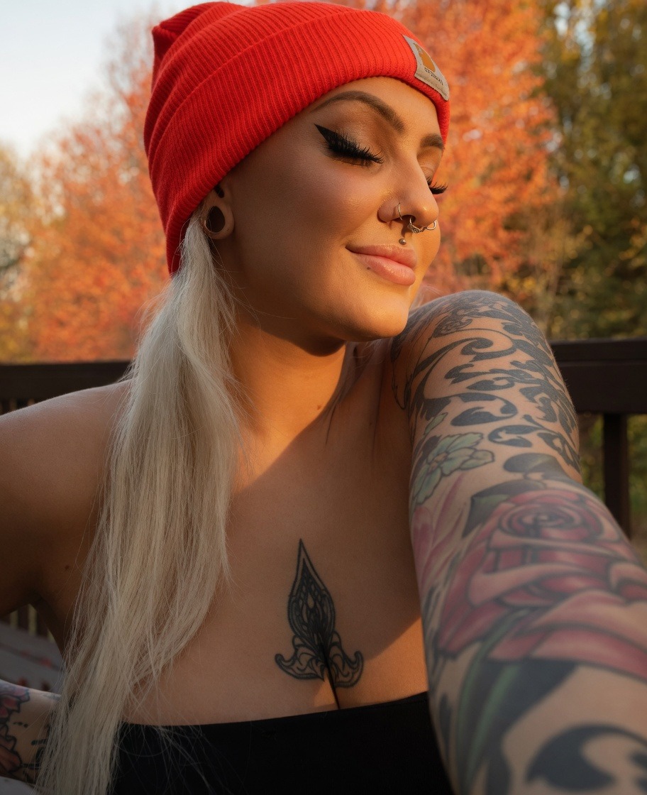Portrait of Alex, barber and hair color stylist, wearing a red beanie